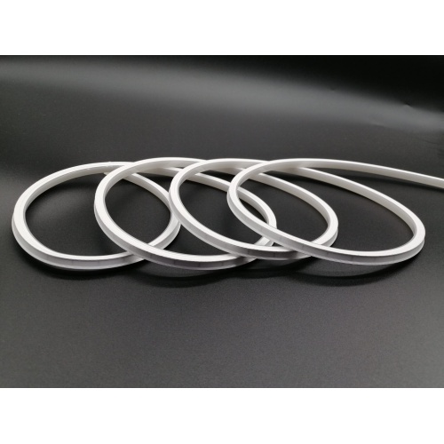 Flexible LED strip coiled on a dark surface, illustrating the adaptability of LED lighting solutions.