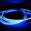 Blue illuminated neon flex LED strip coiled in dark environment