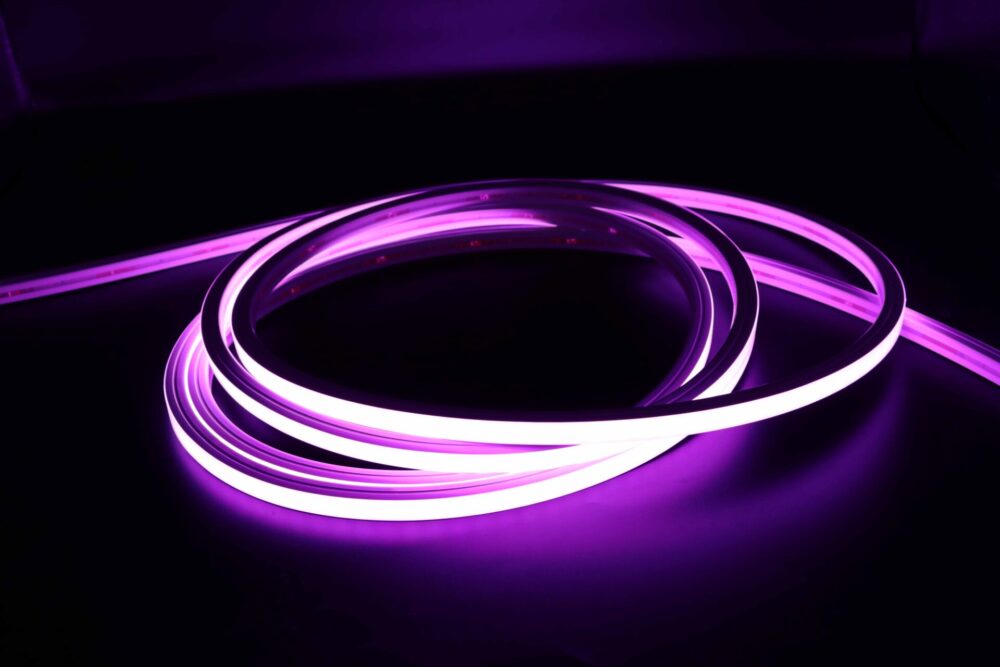Purple illuminated neon flex LED strip coiled in dark environment
